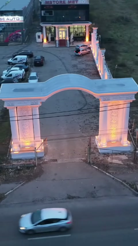 Main entrance arch displayed with symmetrical column clusters and curved cornice