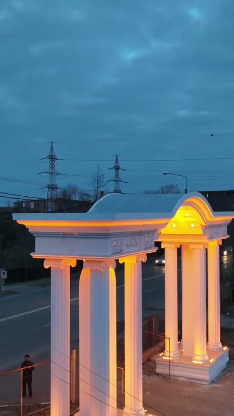 Tall decorative columns and arched crown seen in full profile from the side