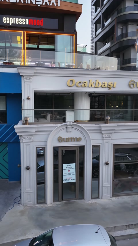 Finished commercial entrance features columns, an arch, and decorative surrounds.