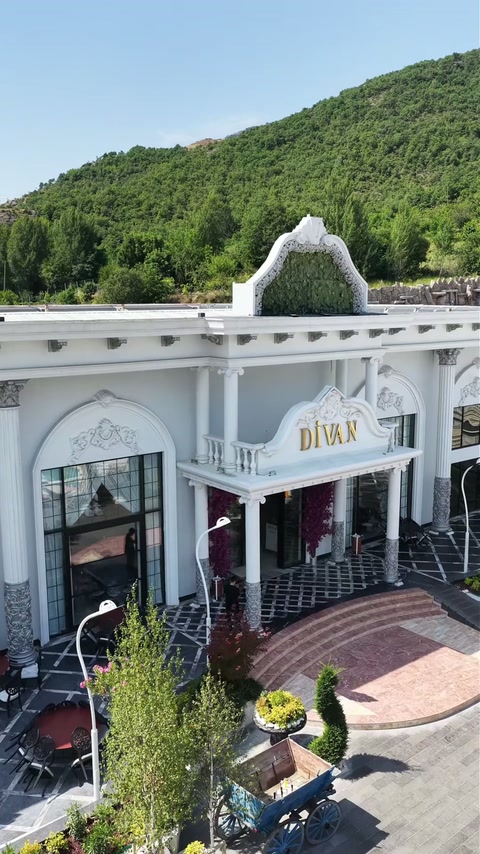 Completed venue facade coordinates arched windows, cornices, and roofline ornaments.