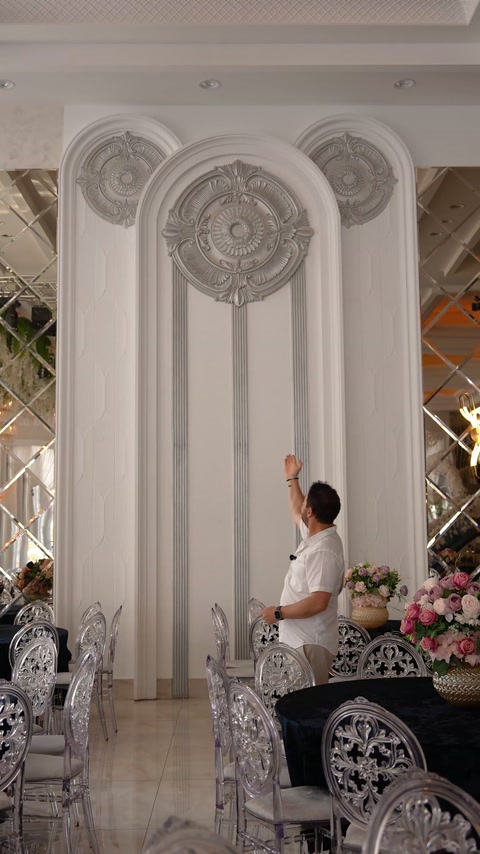 Ornamental wall reliefs and pilasters create a formal interior composition.