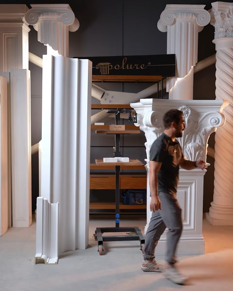 Pilaster column and floor molding panels displayed together in workshop