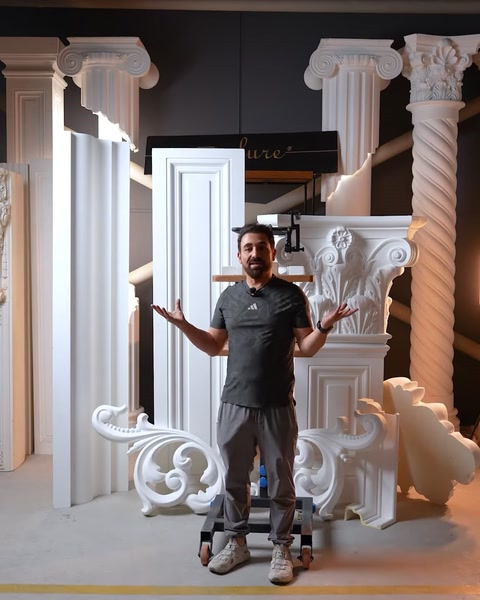 Man presenting finished capital column with scroll applique assembly