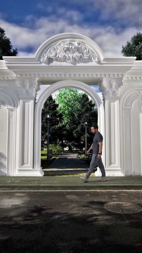 Portale d'ingresso finito con coronamento, colonne e lesene che incorniciano una vista sul giardino