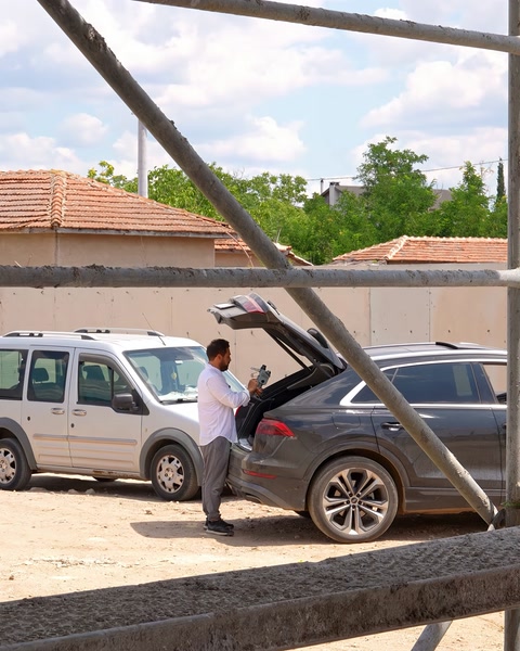 The survey team examines vehicles and equipment at the building site