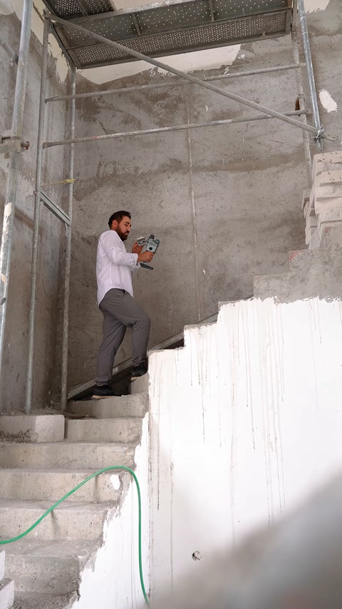 The unfinished wall surface around the staircase is recorded with the scanning device