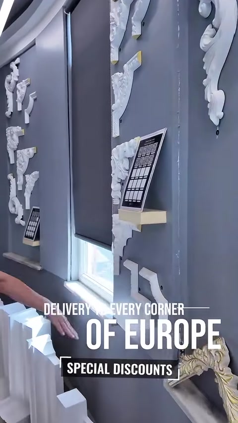 Woman viewing jamb molding samples arranged on display wall