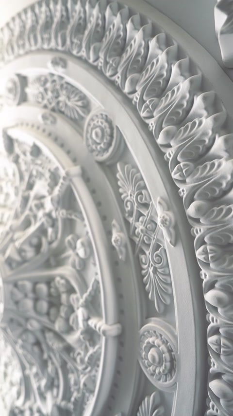 Close-up of layered scalloped pattern on white ceiling rosette edge