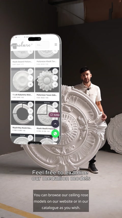 Man holding medallion beside phone screen showing online product catalog