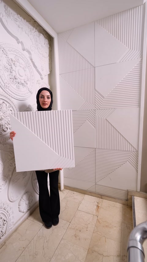 Server displays a square polyurethane panel in front of geometric wall covering