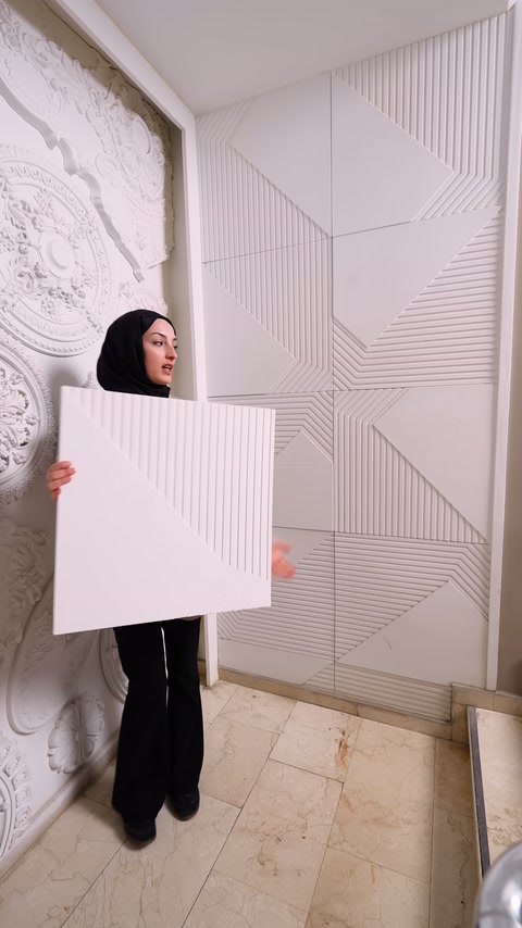 Square polyurethane panel shown from front by server next to patterned cladding