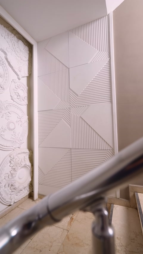 Geometric polyurethane wall covering in stairwell shown in full view