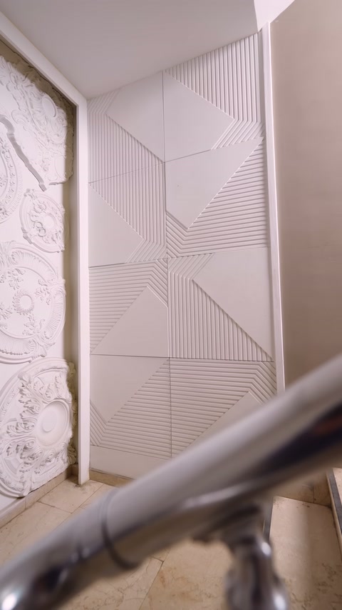 Completed panel wall features regularly arranged triangular embossments forming geometric composition