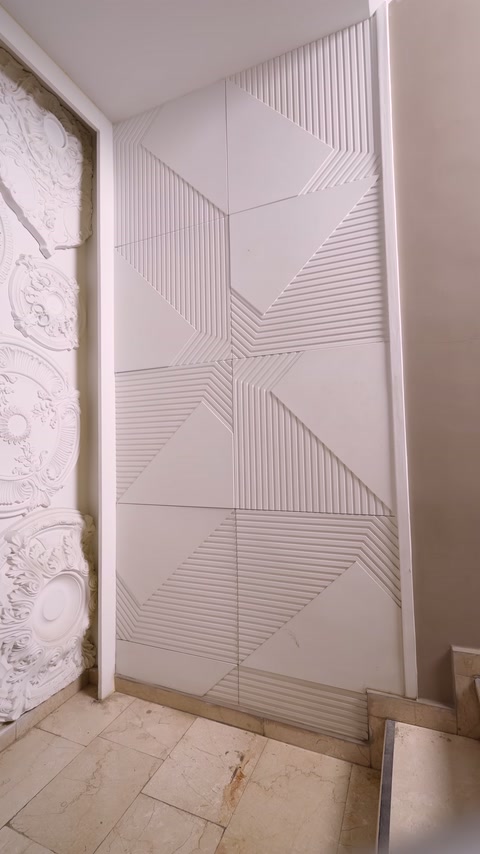 Wall cladding's lined modules extending in different directions displayed
