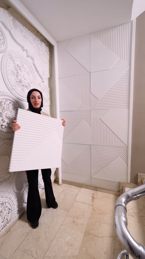Cross-grooved square panel examined in front of applied wall surface