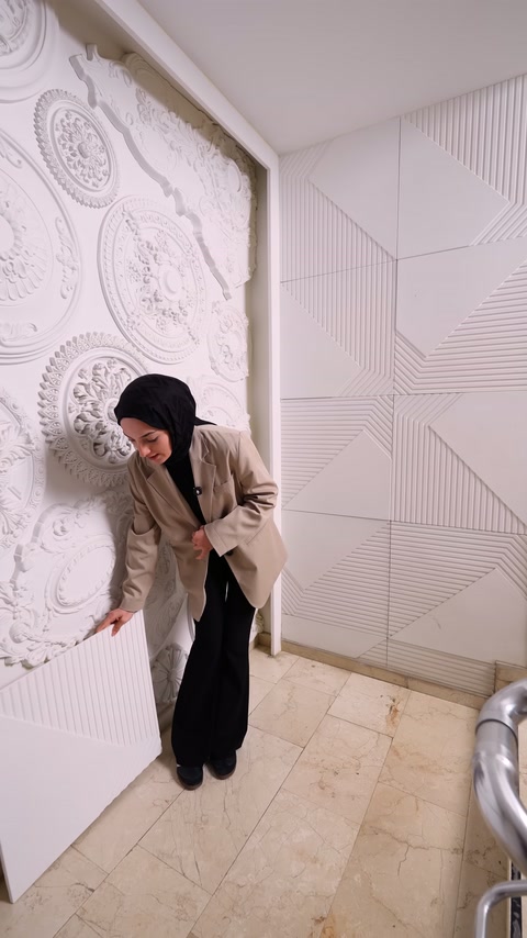 Completed wall cladding remains in background as server sets panel down