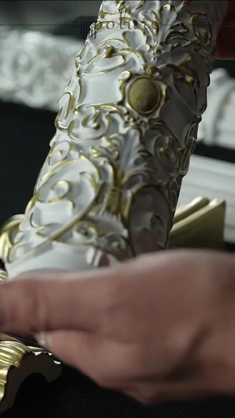 White and gold surface details of an embossed ornament are visible