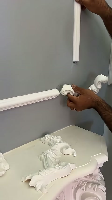 A white corner motif is being moved downward along the vertical trim