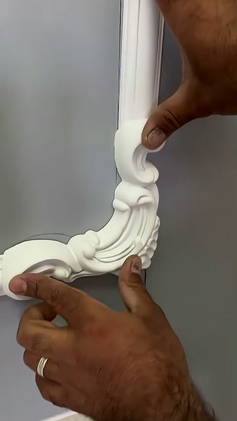 The section of the decorative motif contacting the vertical profile is being pressed