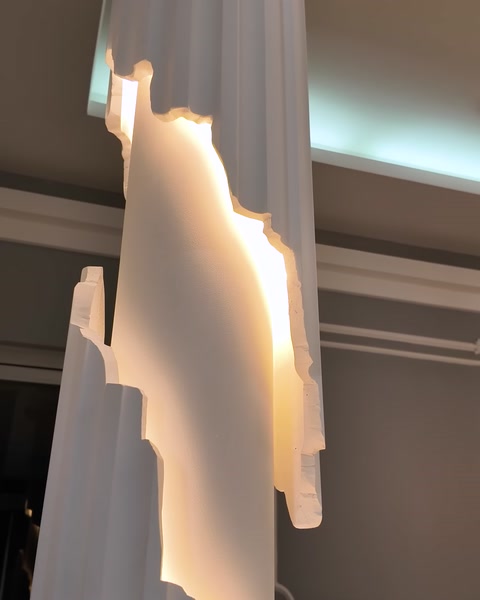 A close-up shows the concealed lighting detail beside a column