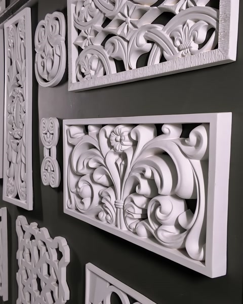 Laser-cut panels with different patterns are displayed side by side on the wall