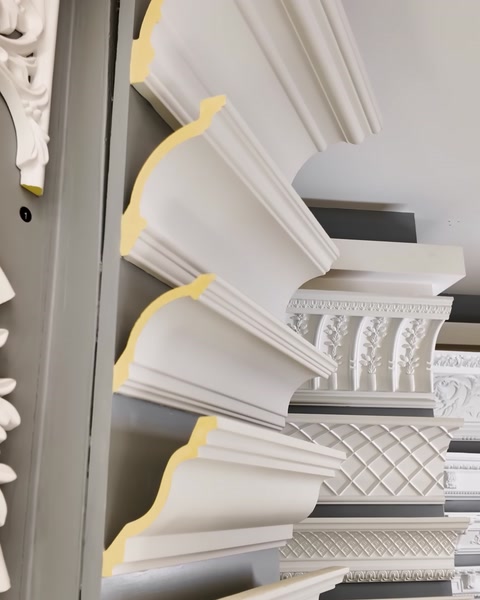 Crown molding profiles are displayed up close in a fan-shaped arrangement