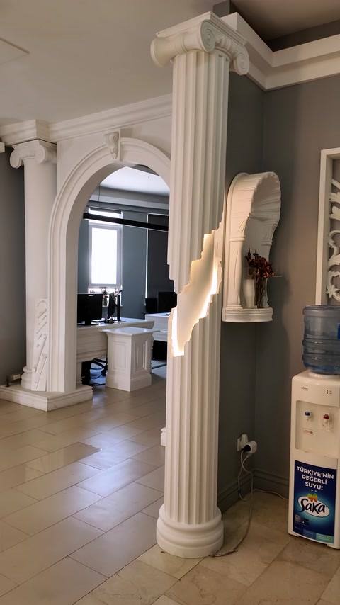 An arched interior passage framed by fluted pilasters