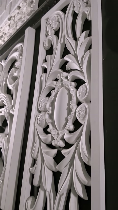 Openwork panel placed vertically shows leaf and oval medallion motifs.