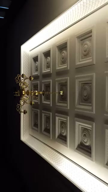 In un'applicazione di soffitto completata, pannelli quadrati in fila circondano il lampadario