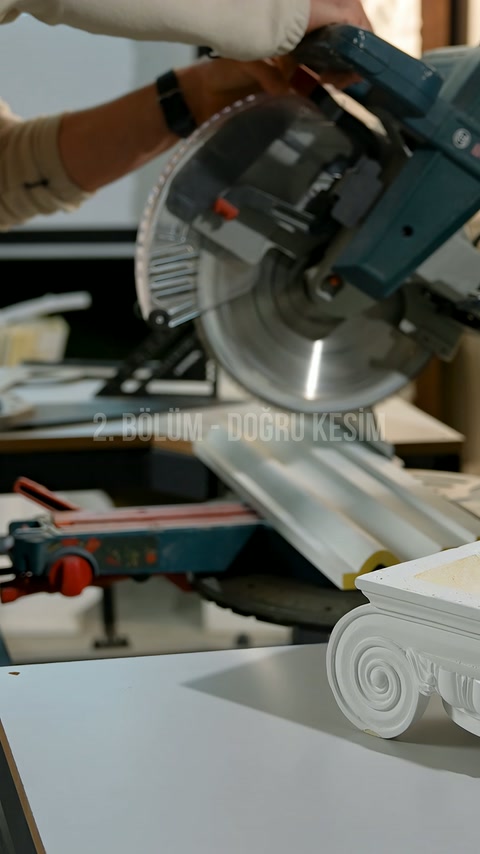 White profile placed on the miter cutting machine is prepared for cutting