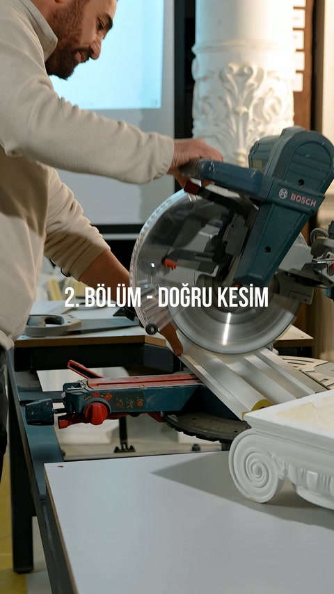 Craftsman shapes the secured white profile using the miter cutting machine