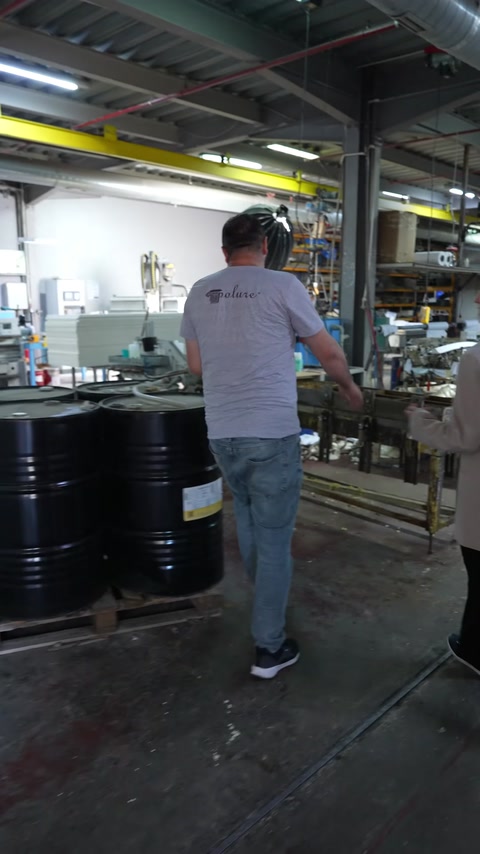 Production staff walk through the workshop where CNC machines are located