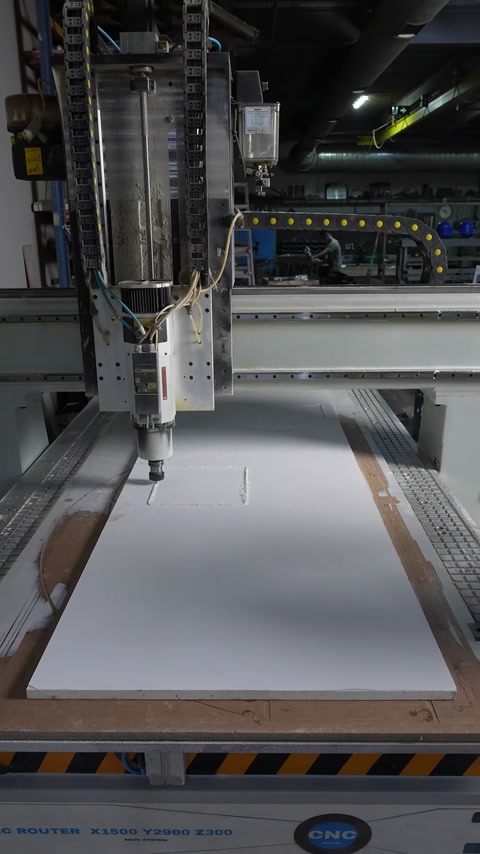 The CNC cutter machines the window module lines on the panel