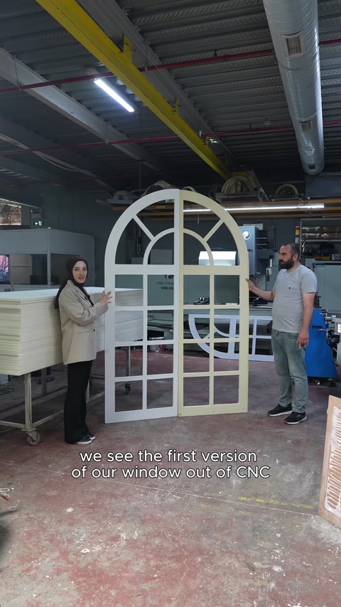 The assembled arched faux window after CNC machining is displayed in the workshop