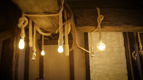Harmony of beams, rope, and wood surfaces in an illuminated space