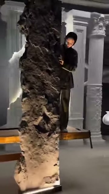 The raised front surface of a canyon-patterned panel is shown by hand