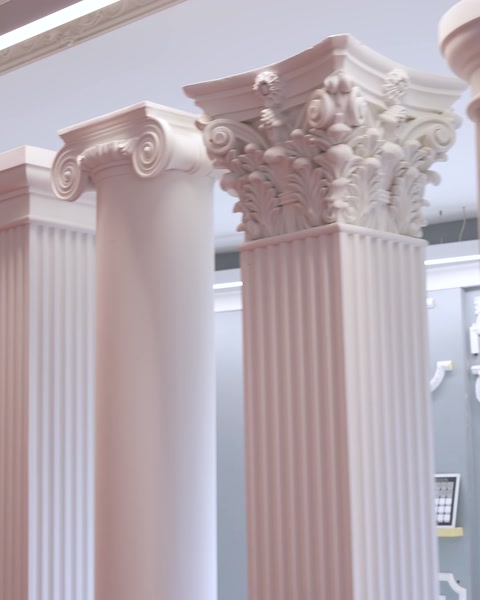 Close-up Corinthian style polyurethane column capitals with fluted shafts