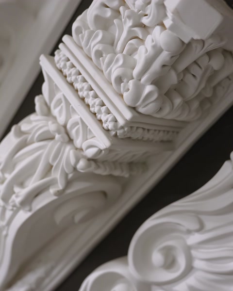 Ornate corbel and cornice corner detail with floral relief carving