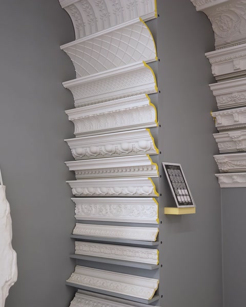 Curved cornice molding profiles mounted for showroom wall display