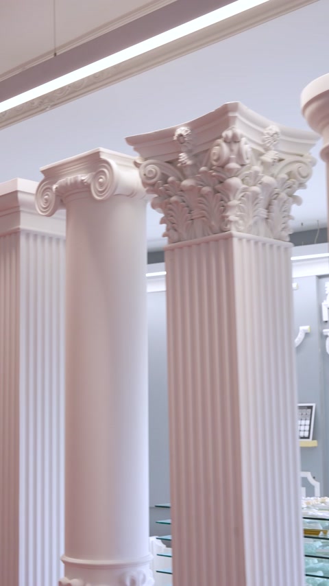 Close-up Corinthian style polyurethane column capitals with fluted shafts