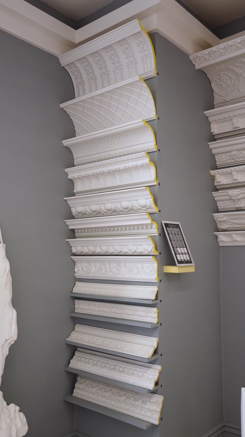 Curved cornice molding profiles mounted for showroom wall display