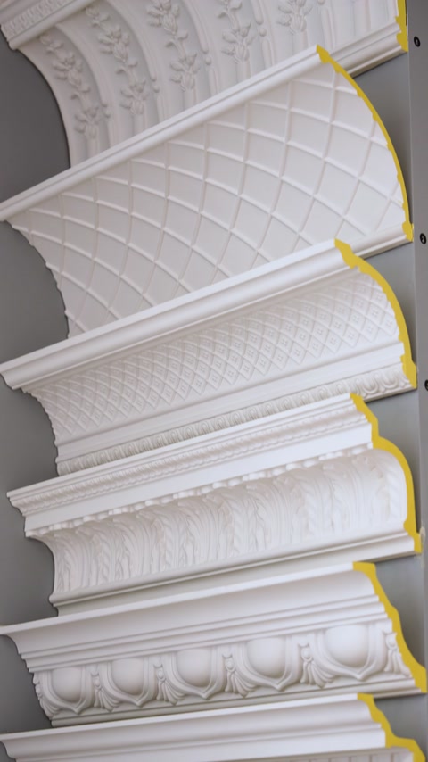 Quilted pattern cornice molding profile shown in stacked showroom display
