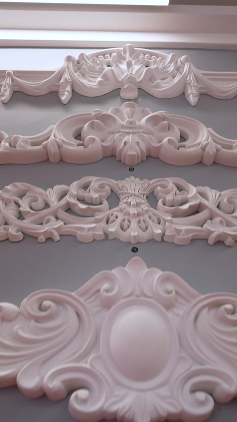 Ornate decorative wall panel with scroll and floral relief pattern