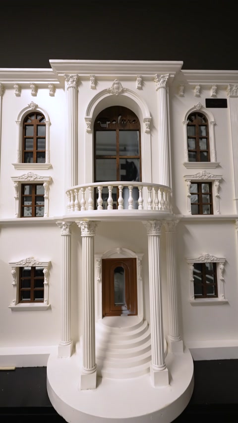 Building facade model with columns, balcony, and window surrounds