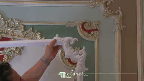 Craftsman positioning the end of white decorative trim close to a corner motif