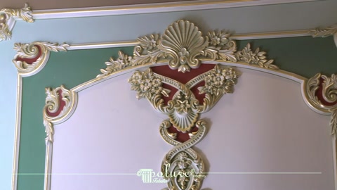 Completed wall frame featuring gold-toned crown molding and curved decorative motifs
