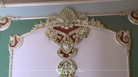 Symmetric polyurethane ornaments displayed in the upper section of a classical wall panel