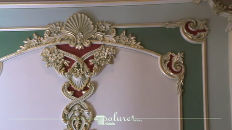Decorative panel corner detailed with white trim and gold accents