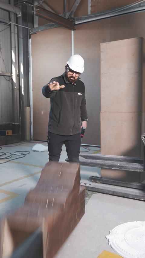 Wood-look hollow beam falls onto the workshop floor during an impact test.