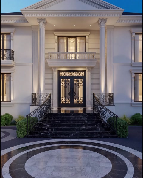 Grand villa entrance framed by columns, balcony mouldings and steps